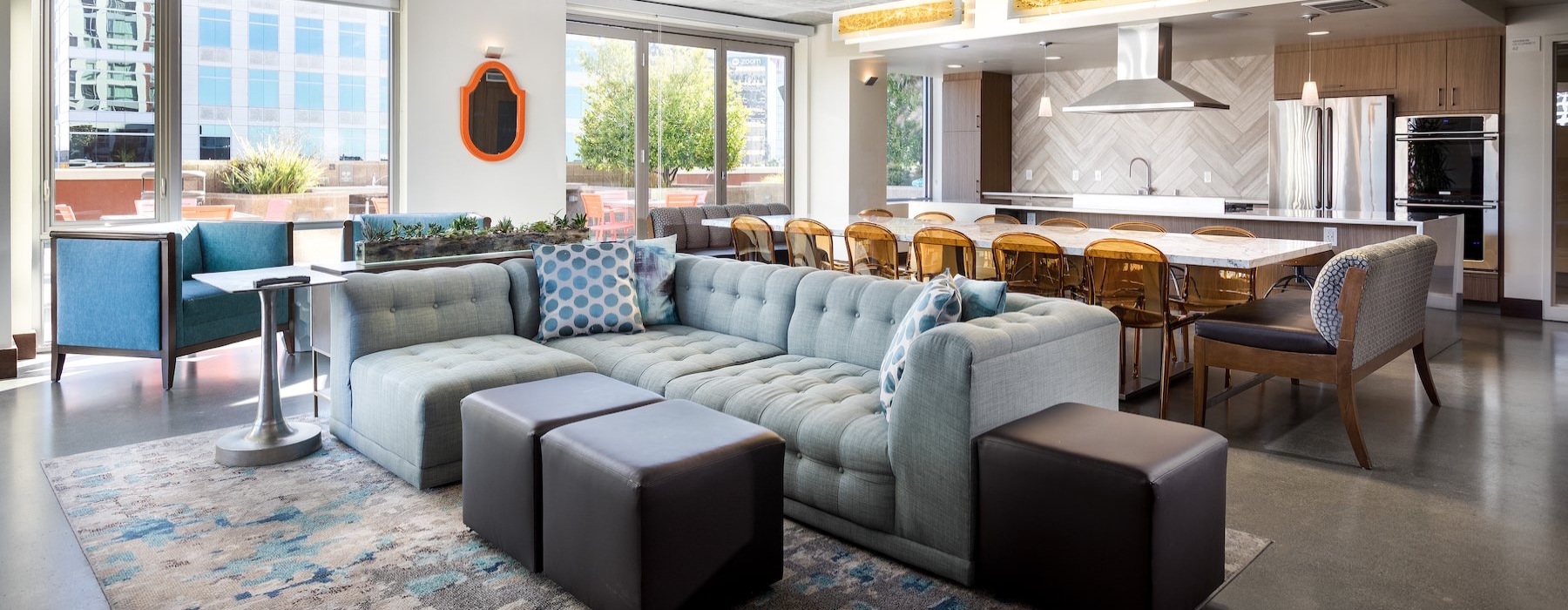 a clubroom with a couch, chairs and tables